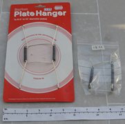 Three Unused Plate Hangers